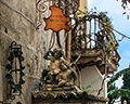 Taormina sculpture and balcony street scene